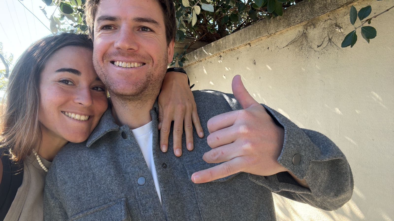 Cristian and his partner outside on a sunny afternoon